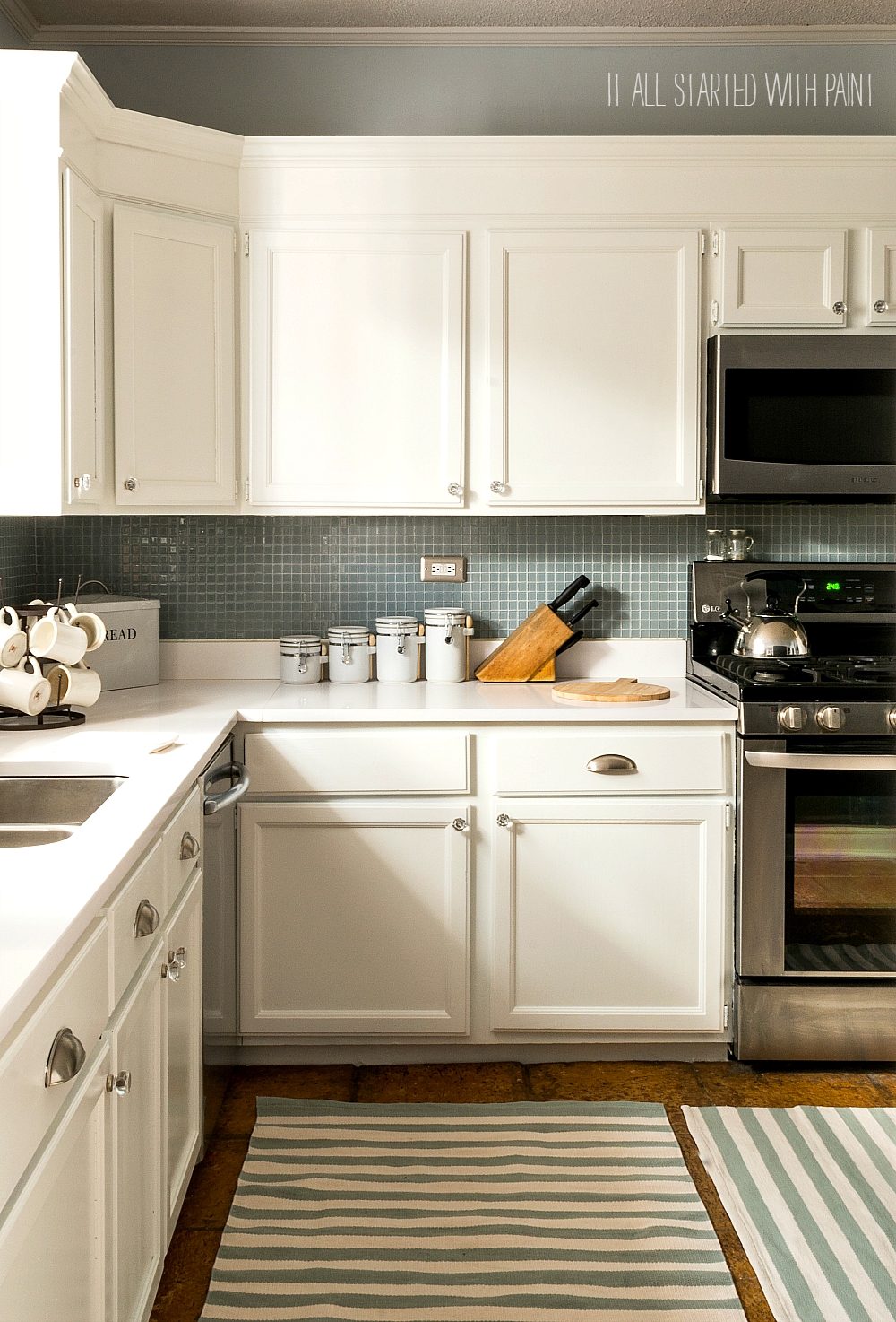 http://www.itallstartedwithpaint.com/wp-content/uploads/2015/08/white-kitchen-cabinets-white-counter-tops-blue-gray-backsplash-12-of-21-2.jpg