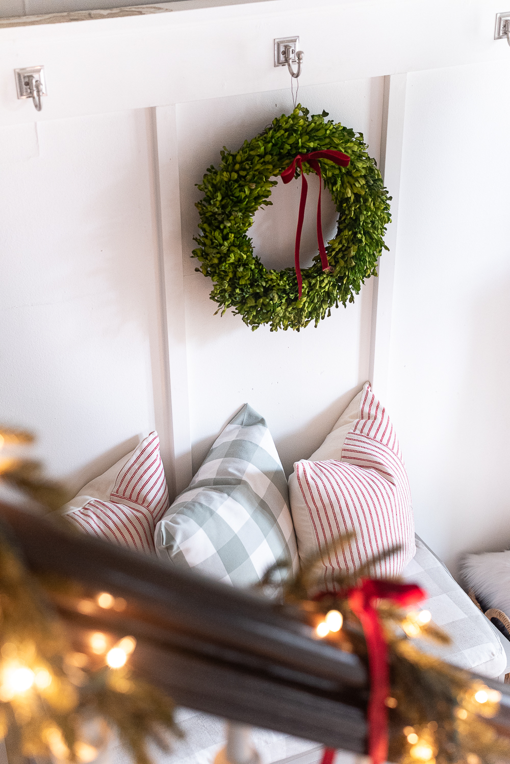 Red, White, Green Christmas Entry Decorating Ideas - Red Velvet Bow on Wreath - Lighted Garland with Red Velvet Bows on Staircase - Decorating Ideas for Entry for Holidays