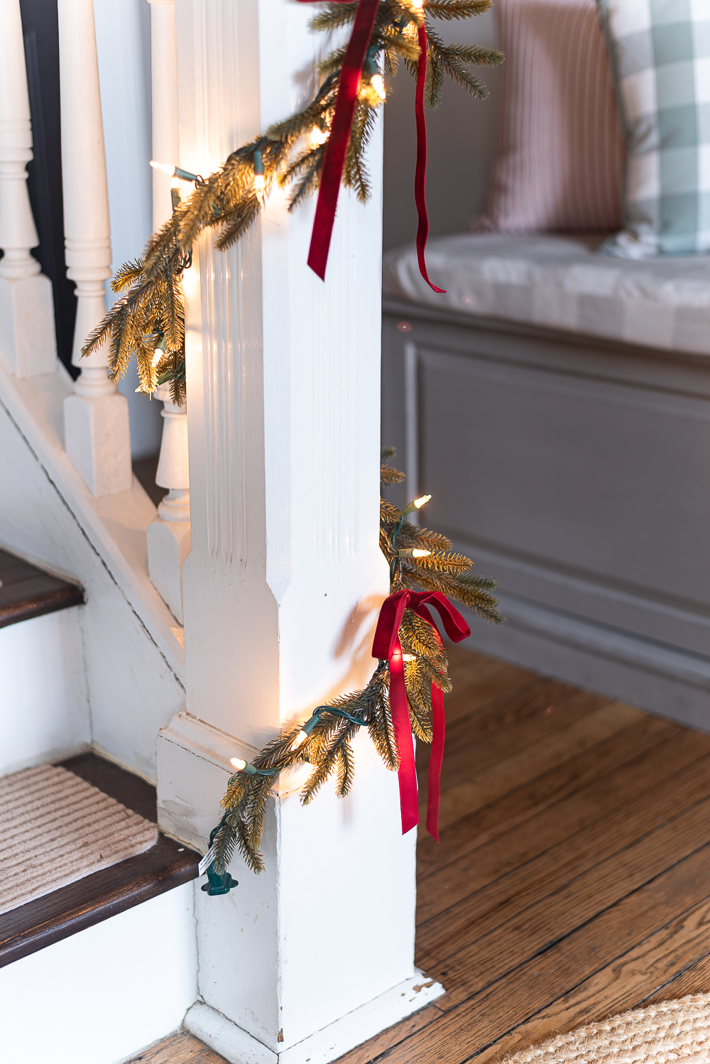 Red, White, Green Christmas Entry Decorating Ideas - Red Velvet Bow on Wreath - Lighted Garland with Red Velvet Bows on Staircase - Decorating Ideas for Entry for Holidays