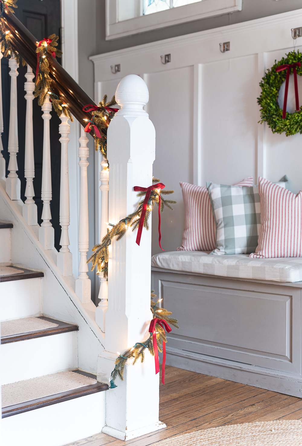 Red, White, Green Christmas Entry Decorating Ideas - Red Velvet Bow on Wreath - Lighted Garland with Red Velvet Bows on Staircase - Decorating Ideas for Entry for Holidays